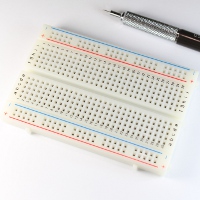 White prototyping breadboard with 30 tie strips and two power rails on each side.